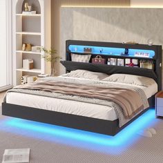 a bed with blue lights on the headboard and foot board is in a room