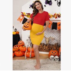 a pregnant woman in a red and yellow dress holding two jack - o'- lanterns