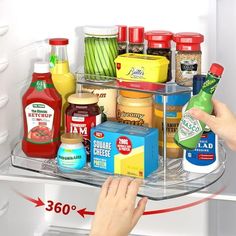 a person reaching into an open refrigerator with food in the bottom shelf and condiments on top