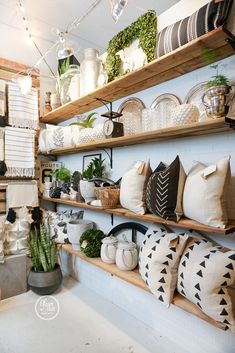 the shelves are filled with decorative items and plants