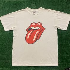 Vintage 90s Rolling Stones Lips Single Stitch Rock Band Tee Size: L Chest: 21" Length: 26" White Short Sleeve Crewneck T-Shirt By Anvil With Red Rolling Stones Hot Lips Tongue Logo Graphic And 1997 Bridges To Babylon World Tour Plane Globe Back Hit. Made In Usa. Single Stitch. Boxy Fit. Essential 1990s Rock Band Tee. Free Shipping On Bundles. Feel Free To Send An Offer. Preowned Clothing May Have Flaws. Please View All Pictures And Ask Any Questions Prior To Purchase. All Sales Are Final. Returns Not Accepted. Check Out Our Other Listings To Bundle And Save! We Have Thousands Of Vintage Graphic Tees In All Sizes And Styles. Follow Us To Catch New Drops - Steals Posted Daily! Thanks For Vintage White Top With Band Logo, 90s Band Logo Relaxed Fit Top, 90s Band Logo Top With Relaxed Fit, 90s Relaxed Fit Top With Band Logo, Rolling Stones Shirt, Rock Band Tees, Vintage Graphic Tees, Vintage Mens T Shirts, Hot Lips