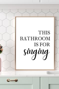 this bathroom is for singing poster in black and white with pink flowers on the counter