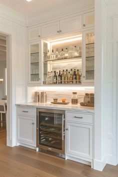 a kitchen with white cabinets and an oven in the center is lit by recessed lighting