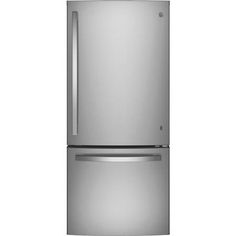 a silver refrigerator freezer sitting on top of a white wall