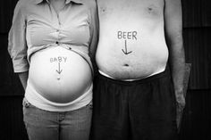 two people standing next to each other with the words beer and baby written on their stomachs