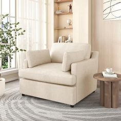 a living room with a chair, coffee table and potted plant in the corner