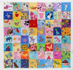 a colorful patchwork quilt with lots of pictures on it