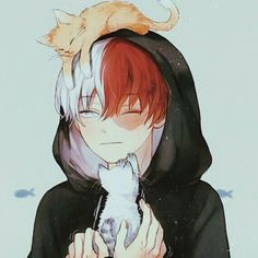 a person holding a cat in their arms and wearing a hoodie over his head