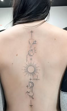 the back of a woman's neck with tattoos on her upper and lower back