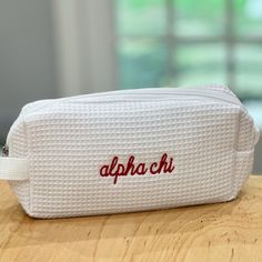 a white bag with the word apoth on it sitting on top of a wooden table