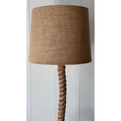 a lamp that is on top of a wooden base with rope wrapped around the bottom