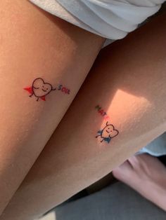 two small tattoos on the thighs of women