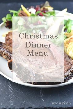 a christmas dinner menu on a plate with salad and meat in the middle, including roast beef