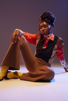 a woman is sitting on the floor with her legs crossed and wearing yellow socks,