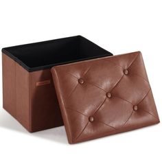 a brown leather storage box with buttons on the front and bottom, sitting next to a black square container