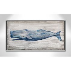 a blue whale is hanging on the wall in front of a wooden paneled background