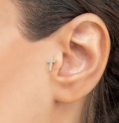 a woman's ear with a cross on it