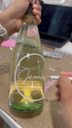 someone is painting the inside of a glass bottle