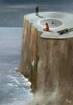 a man standing on top of a cliff next to the ocean