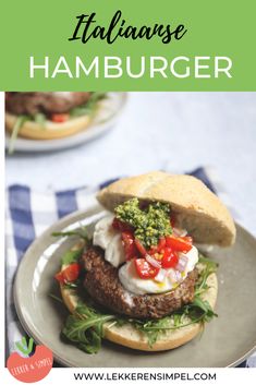 an italian hamburger with lettuce, tomatoes and cheese on it is served on a plate