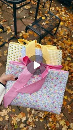 a person is holding two bags with ribbons on them