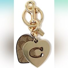 a heart shaped key chain with the letter c on it's front and side