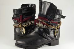 a pair of black boots with chains on them