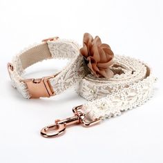 a white lace dog leash with a flower on the end and a pink metal buckle