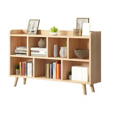 a book shelf with books, vases and pictures on it in front of a white background