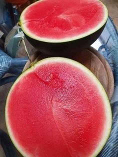 two pieces of watermelon sitting on top of each other in front of a basket