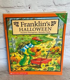 the franklin's halloween book is on display in front of a white brick wall