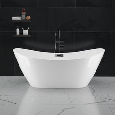 a white bath tub sitting in a bathroom next to a black tiled wall and floor