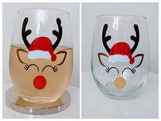 two wine glasses decorated with reindeer noses and nose hats, one is clear and the other has red nose