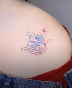 a woman's stomach with a cat tattoo on her belly and the moon behind it