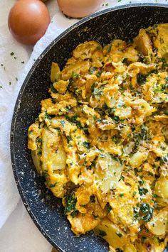 an egg dish in a skillet next to eggs