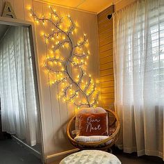 a chair and ottoman in a room with lights on the wall