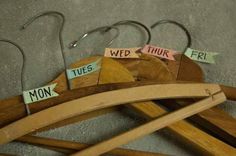 wooden clothes hangers with words on them and clips attached to the hooks that are labeled'wed, thur, monk, wed, tur, fri