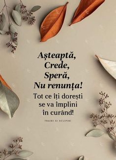 some leaves and flowers on a table with the words asteptia, crede, spera, nu renuna