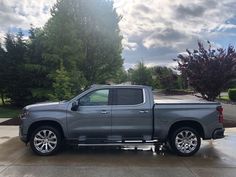 a silver truck is parked in the driveway