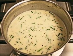 a pot filled with soup sitting on top of a stove