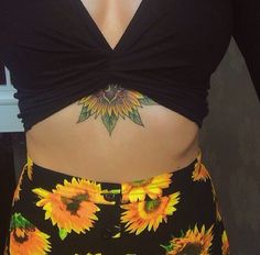 a woman with sunflowers on her stomach