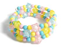 The pastel star bracelet comes in pink, blue and yellow. It easily coils around the wrist. One size fits all. More bracelets: https://www.etsy.com/shop/Allysin?ref=seller-platform-mcnav&search_query=bracelet Have a look at my other shop: Unique gemstone jewelry: http://jewelicide.etsy.com Pixie Party, Pastel Bracelet, Coil Bracelet, Rose Bleu, Kawaii Jewelry, Pink Blue Yellow, Beads Bracelet Design, Star Bracelet, Beaded Accessories