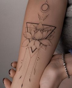 a woman's arm with a lotus tattoo on it