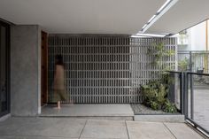 a woman is standing in an open courtyard