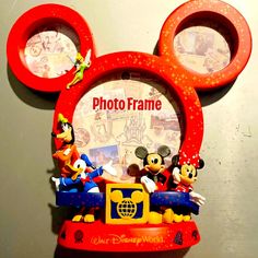 the mickey mouse photo frame is on display with other disney characters in front of it