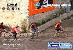 three people riding bikes down a cobblestone road