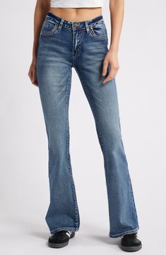 A '70s groove defines these stretch-kissed jeans that feature flared legs and embroidered stars at the back pockets 35 1/2" inseam; 22" leg opening; 9" front rise;15" back rise (size 29) Zip fly with button closure Five-pocket style 69% cotton, 26% polyester, 3% viscose, 2% elastane Machine wash, line dry Imported Embroidered Denim Blue Cotton Flare Jeans, Mid-rise Indigo Flare Jeans, Embroidered Mid-rise Denim Flare Jeans, Luxury Mid-rise Flare Jeans With Five Pockets, Affordable Button-detail Flare Jeans, Flare Leg Jeans, Fabric Gift Bags, Nordstrom Store, Free Fabric