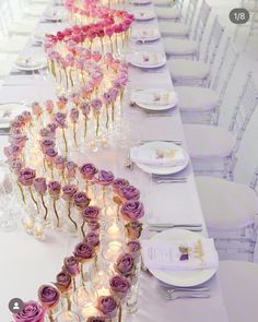 a long table is set with flowers and candles