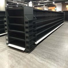 empty shelves in a store with lights on