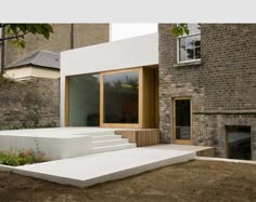 a modern house with white steps leading up to the front door and side entrance area